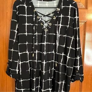 Black and white three-quarter length sleeved top with fun V-neck with drawstring